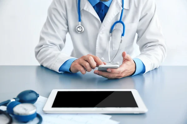 Male doctor at work in clinic office