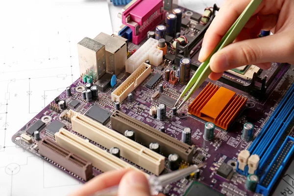 Man repairing motherboard, closeup