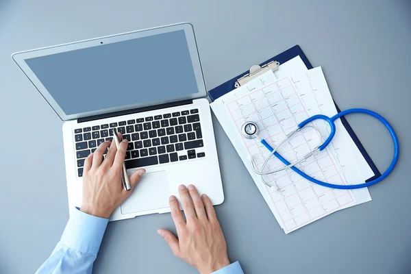 Male doctor at work in clinic office