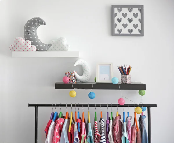 Decorative shelves on wall as detail of kid room interior