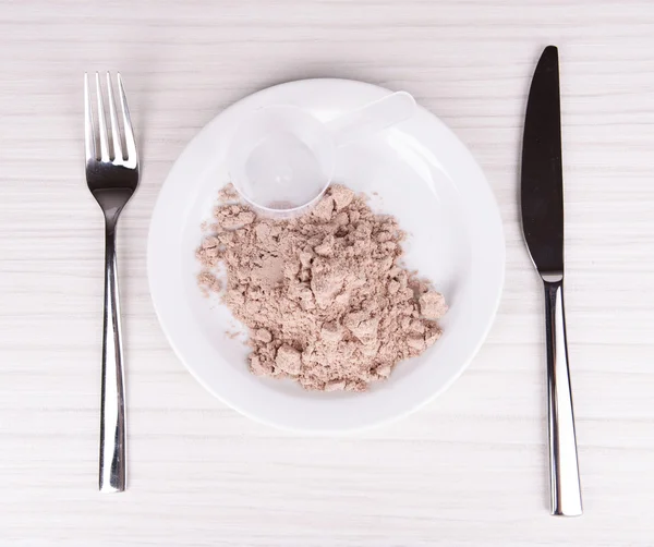 Whey protein powder on plate with scoop on wooden background