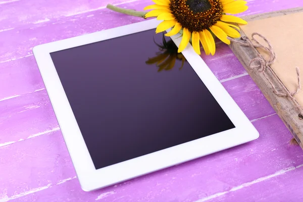 Tablet, notebook and sunflower