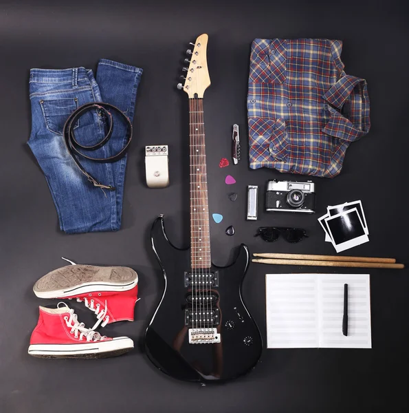 Musical equipment, clothes and footwear on dark background