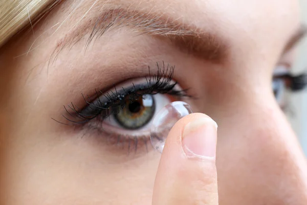 Young woman with contact lens