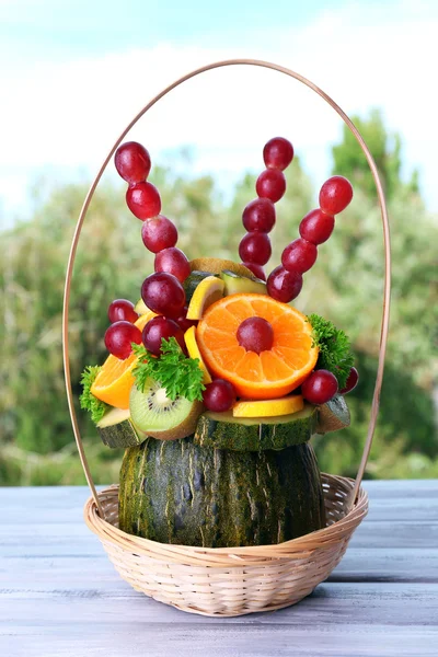Table decoration made of fruits on table on natural background