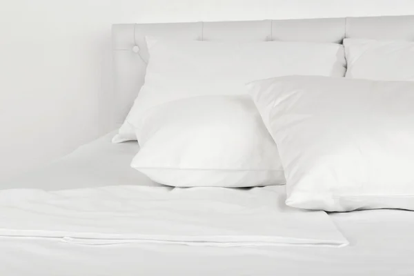 White pillows on bed in room