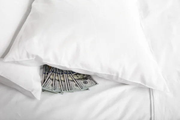 Hidden money under pillow close up