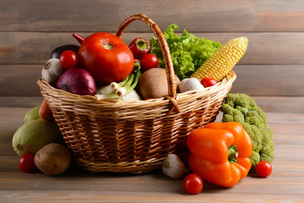 Fresh organic vegetables on wooden background