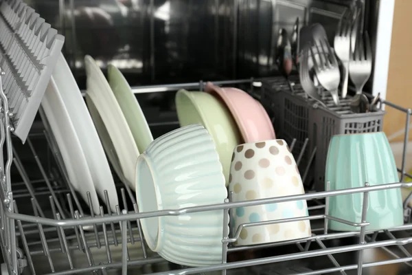 Open dishwasher with utensils