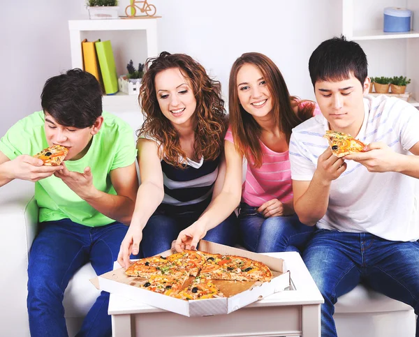 Young friends eating pizza
