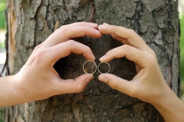 Two hands with wedding rings