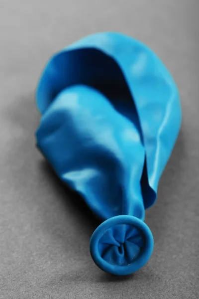 Popped blue balloon