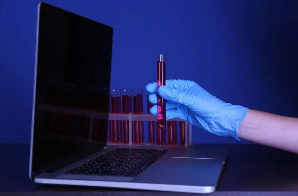 Scientist entering data on laptop computer