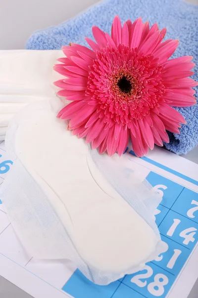 Sanitary pads, calendar, towel and pink flower