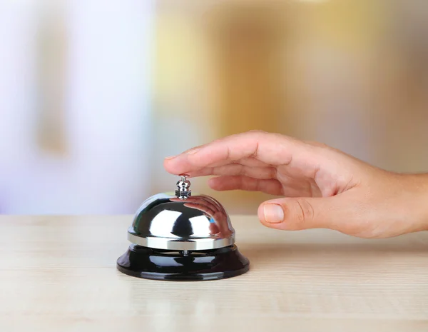 Hand ring bell on  hotel reception desk