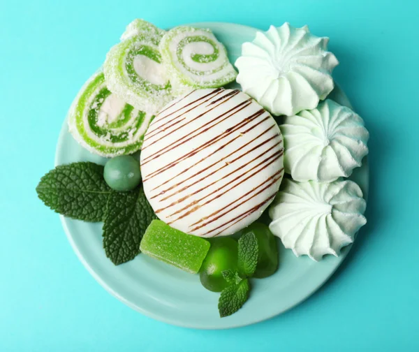 Mint color meringues, mint candies and cake