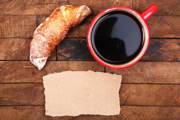 Coffee, fresh croissant and paper card