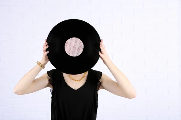 Young woman holding retro record