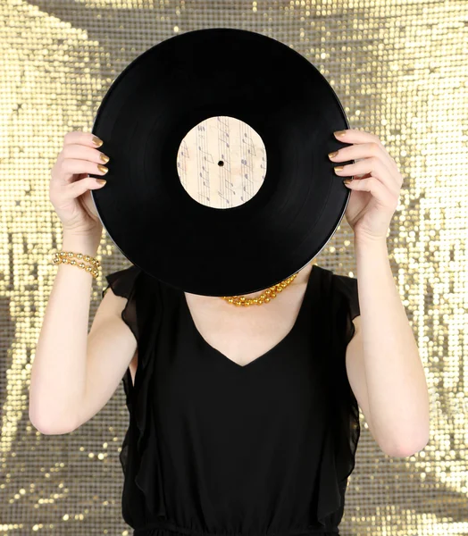 Young woman holding retro record