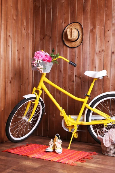 Yellow retro bicycle in wooden house