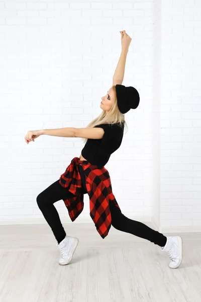 Hip hop dancer dancing on wall background