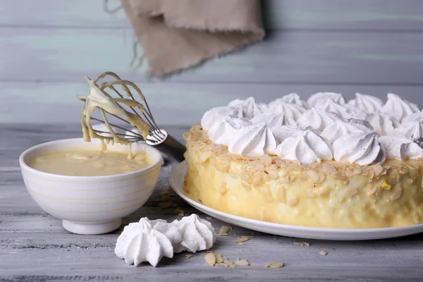 Tasty homemade meringue cake on wooden table