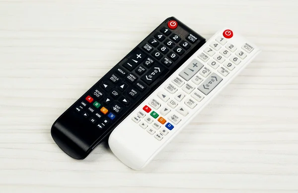 Two remote control devices on table