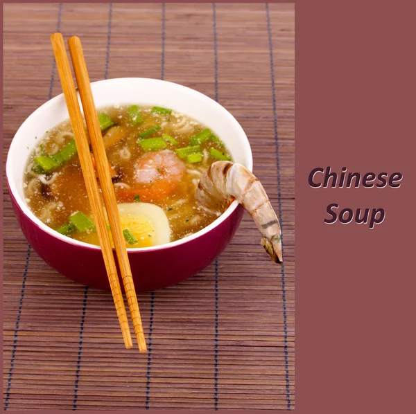 Chinese soup in bowl on bamboo mat and sample text