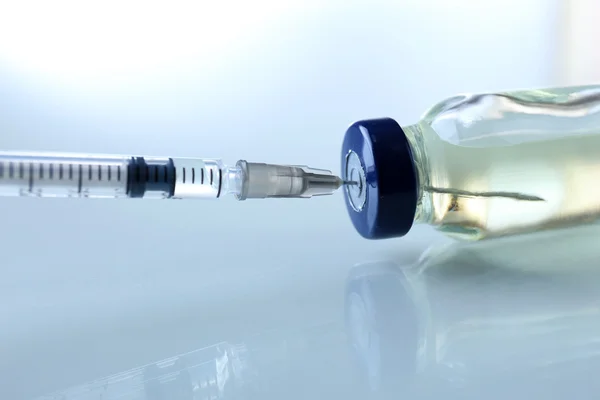 Vaccine in vial with syringe