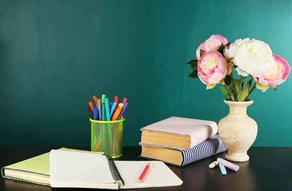 Desk with books and flowers