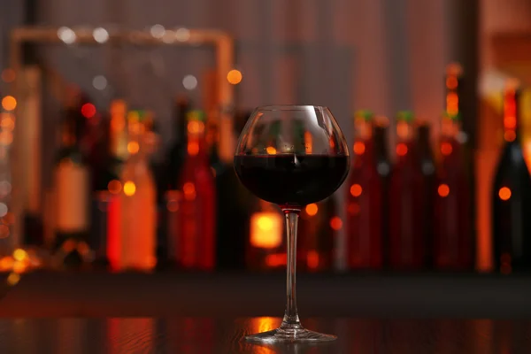 Glass of red wine in bar on blurred background