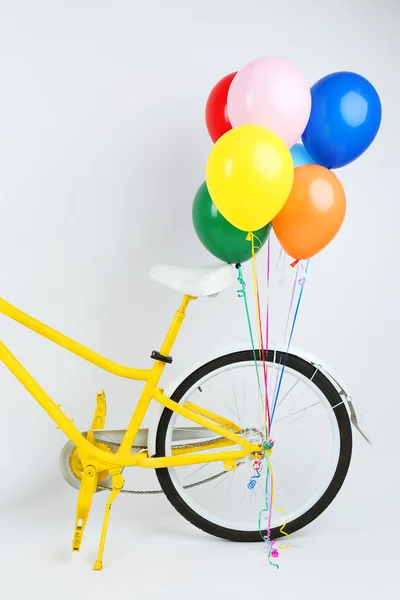 Yellow bicycle with balloons