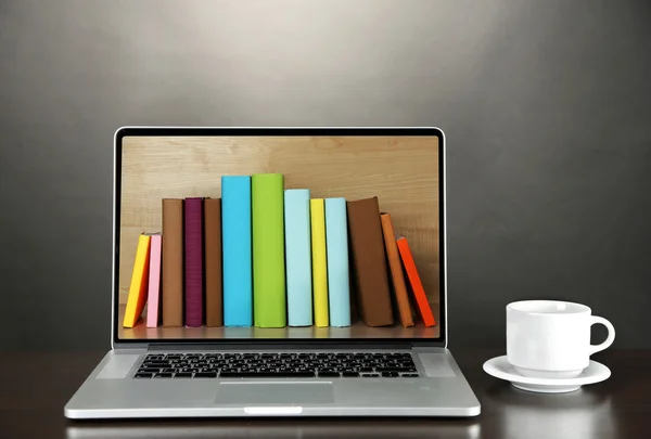 E-learning concept.  Digital library - books inside laptop