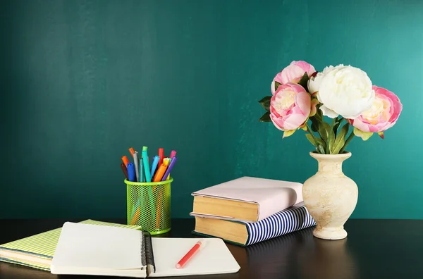 Desk with books and flowers