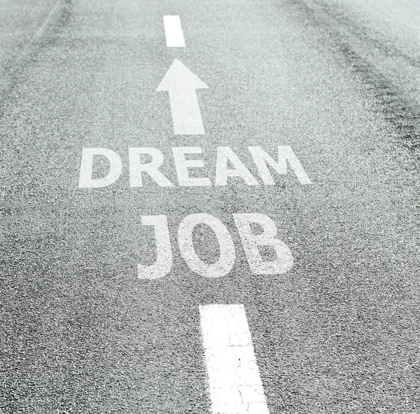 Text Dream Job with arrow marking on road surface