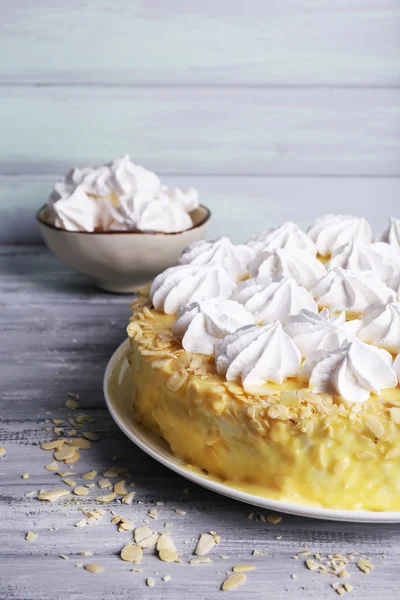 Tasty homemade meringue cake on wooden table