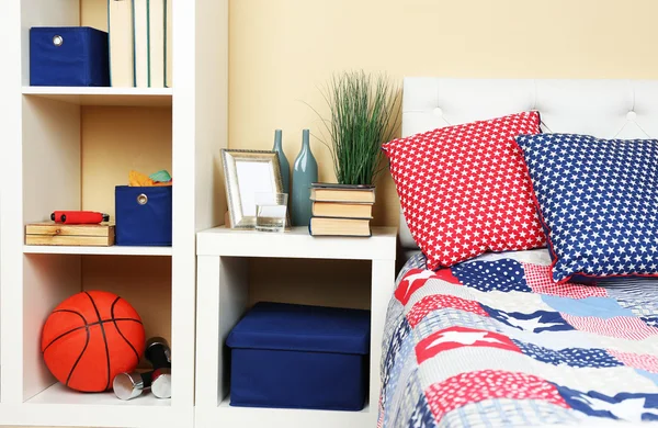 Modern colorful bedroom interior with bed and nightstand, with design details on light wall background