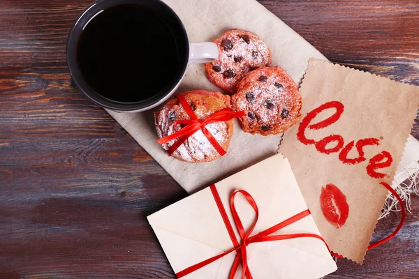 Love letters with coffee and cookies on wooden background