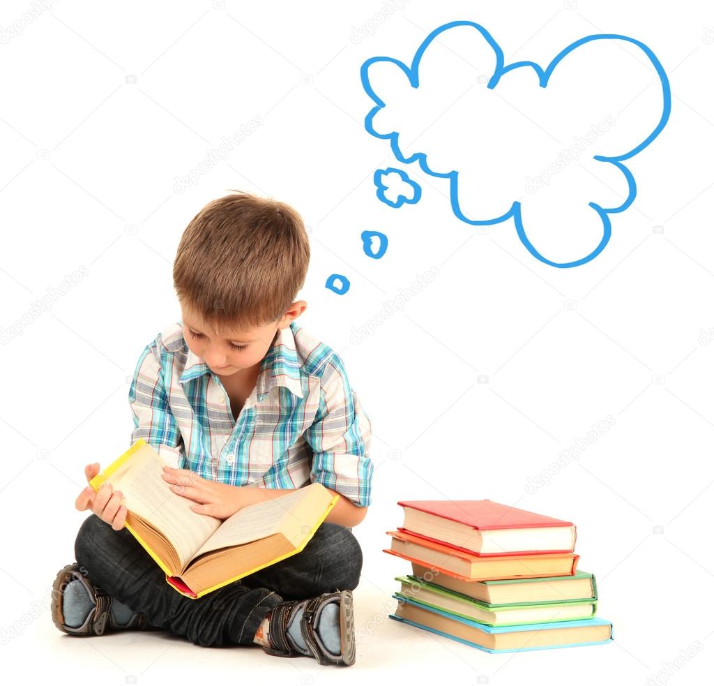Cute little boy dreaming about something while reading book isolated on