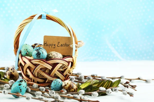 Bird eggs in wicker basket on bright background