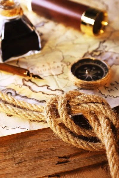 Marine still life with world map and rope on wooden table background