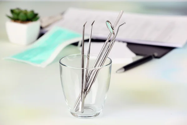 Dentist tools in glass table close up