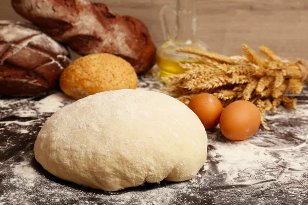 Making bread on table on wooden background