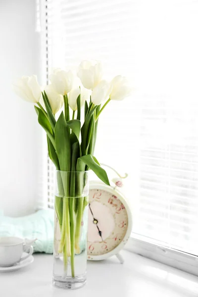 White beautiful tulips in light interior