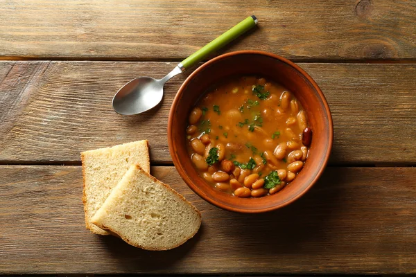 Bean soup in bowl on wooden table background
