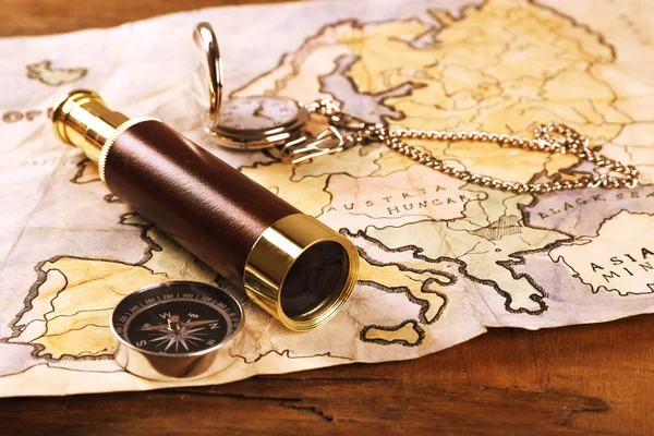 Marine still life with world map and spyglass on wooden table background