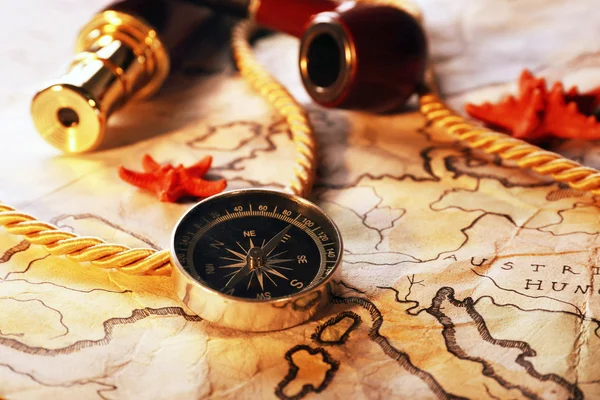 Marine still life with world map and spyglass on wooden table background