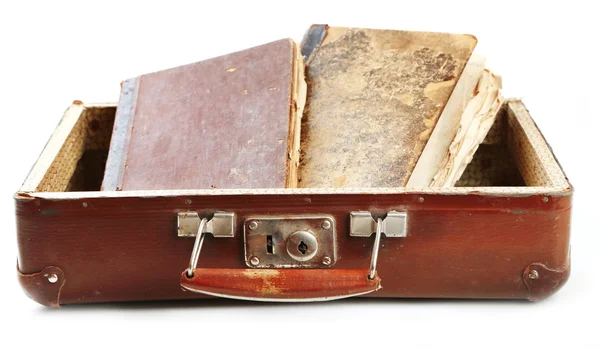 Old wooden suitcase with old books isolated on white
