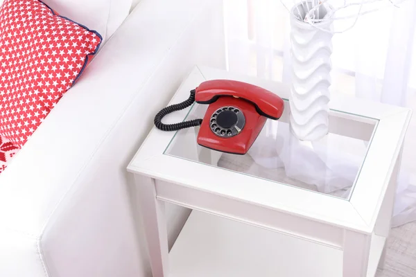 Retro phone on nightstand in room