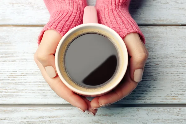 Female hands holding cup of coffee